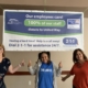 Three Tax Collector Employees standing under United Way banner.